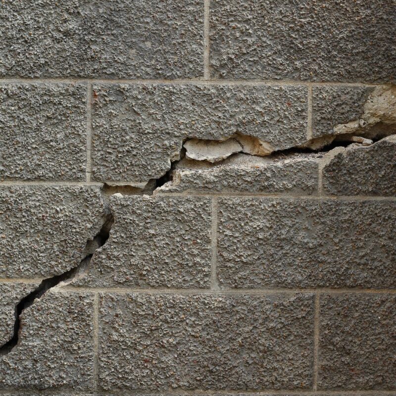Stair-step crack running through a concrete block foundation wall